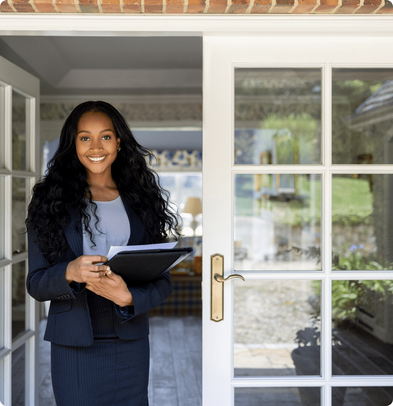 Businesswoman holding documents at entrance