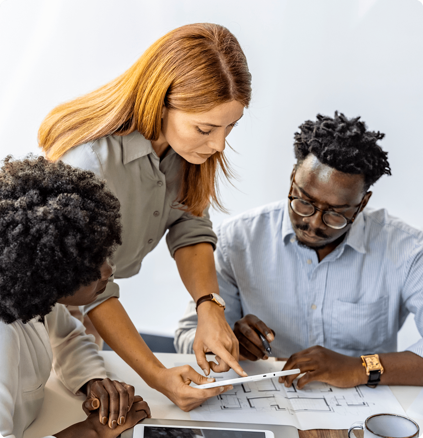 Team collaborating over architectural plans